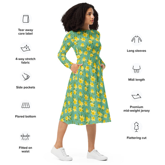 Woman wearing a green dress with yellow daffodil floral pattern by Carmel Rimmer, standing against a white background with product features listed.