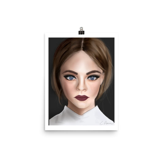 A framed poster print by Carmel Rimmer featuring a portrait of a woman with blue eyes and short brown hair, wearing a white top, against a black background.