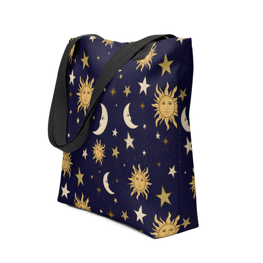 Navy blue tote bag with celestial pattern featuring suns, moons, and stars on a white background