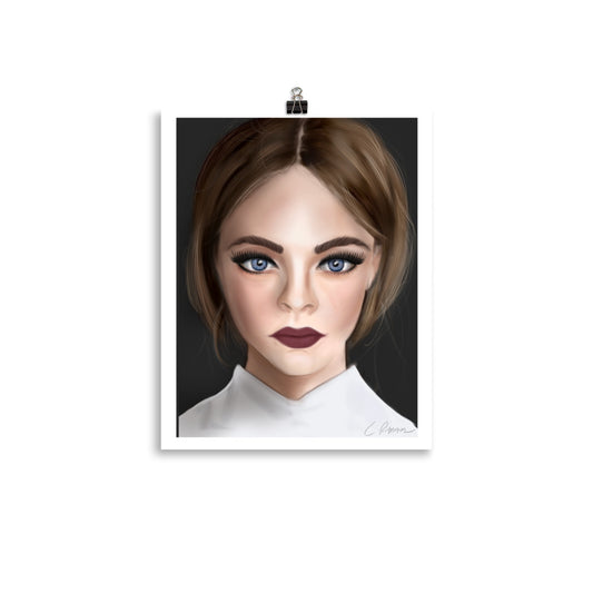 A framed poster print by Carmel Rimmer featuring a portrait of a woman with blue eyes and short brown hair, wearing a white top, against a black background.